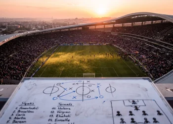 A conceptual representation of a football stadium and tactical planning board.