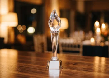 A close-up of a glass award trophy on a table.