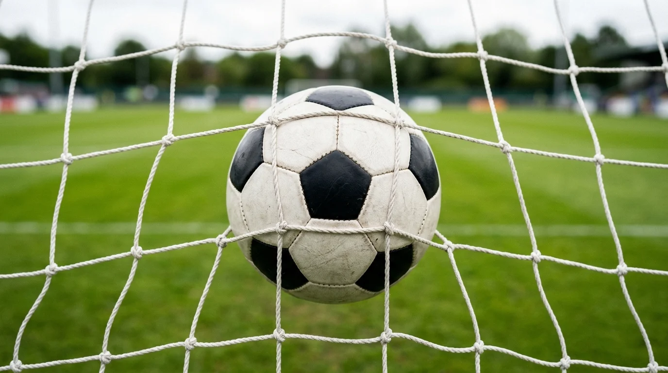 A football in the back of a net.