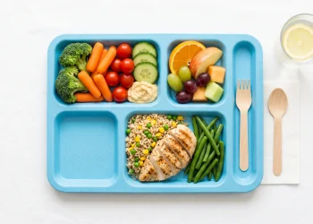 A conceptual image of a healthy school meal with fruit and vegetables.