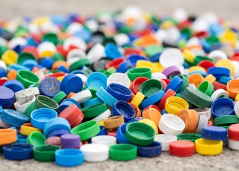 A close-up view of various colourful plastic bottle tops.